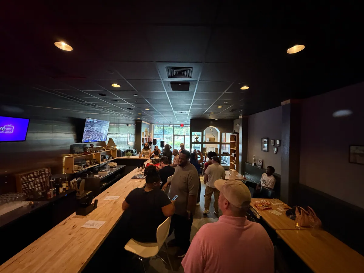 The long wooden bar under warm downlights