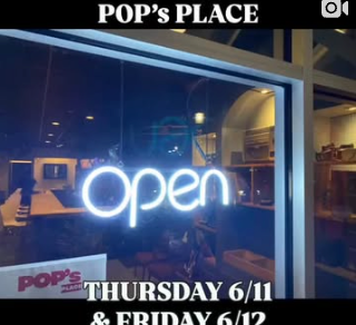 The neon open sign in the window at Pop’s Place