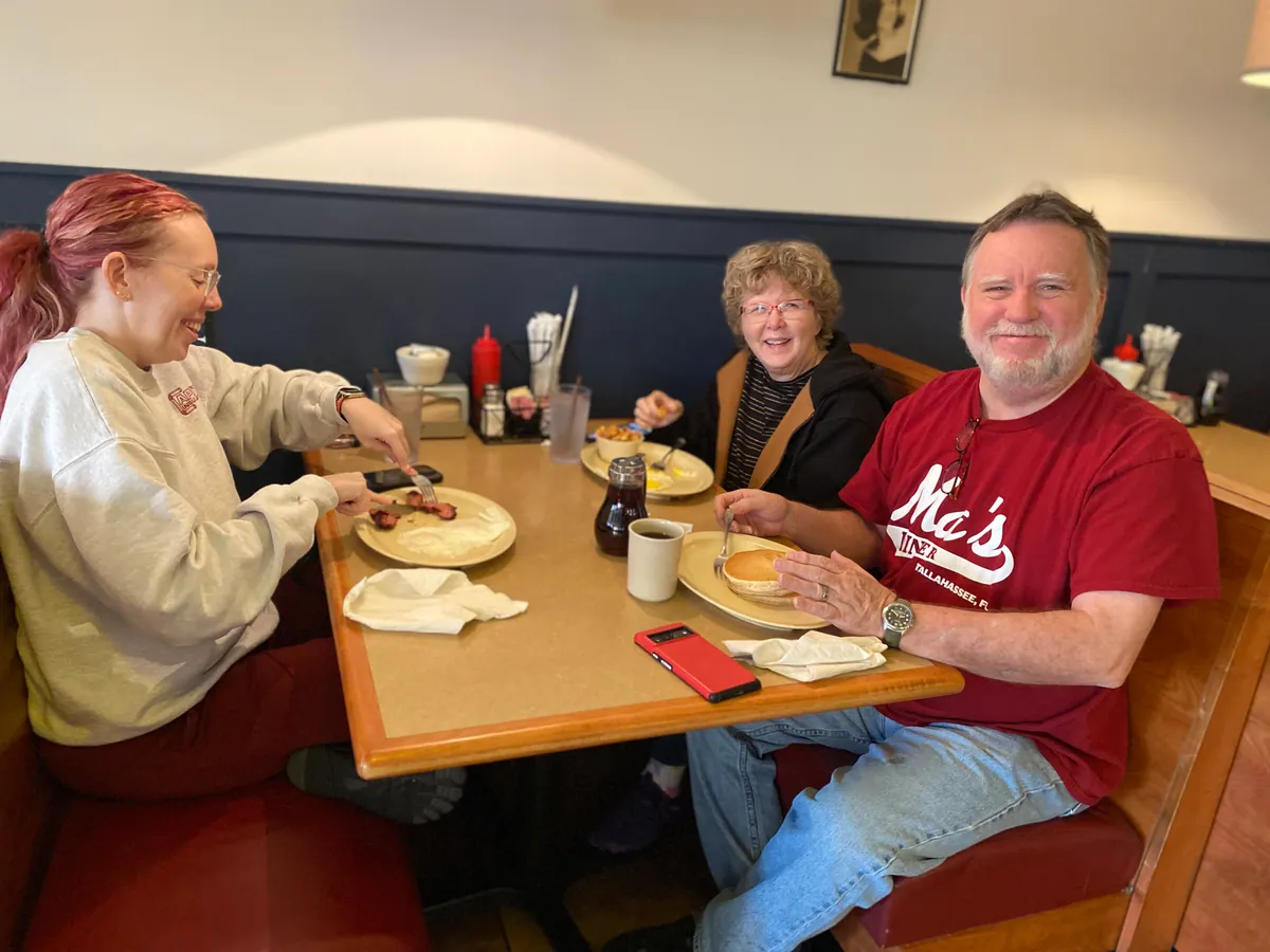 A family sharing breakfast in a booth at Ma’s Diner